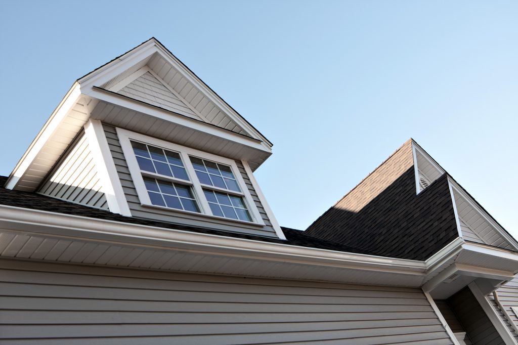 Close up view of a newly built house rooftop soffit and dormers.